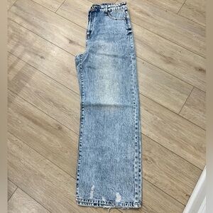 Light wash baggy jeans with distressed bottom.